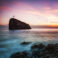 Seascape. Seacoast at sunset and a cross on a rock