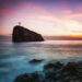 Seascape. Seacoast at sunset and a cross on a rock